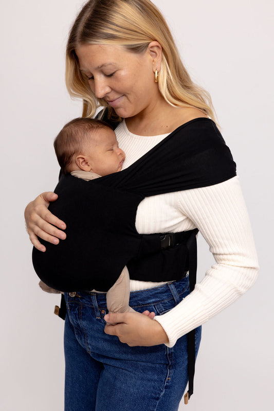 Mom wearing WildBird Raven Newborn Buckle Wrap with newborn front carry CloudBlend fabric
