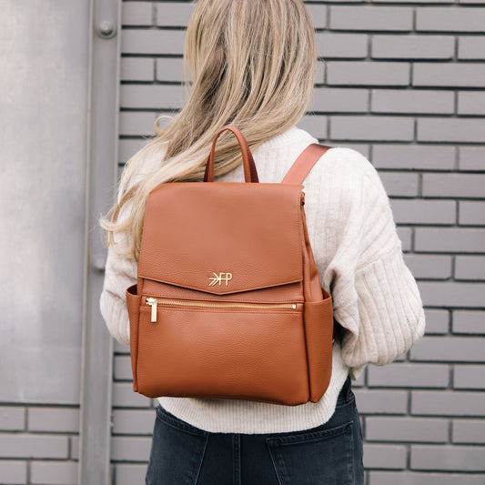 Mom with Freshly Picked cognac vegan leather mini diaper bag backpack with grab-and-go handle