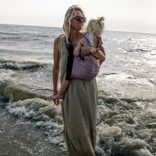 Mom holding a toddler ith Widride sling carrier