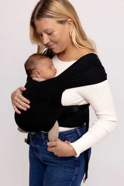 Mom wearing WildBird Raven Newborn Buckle Wrap with newborn front carry CloudBlend fabric