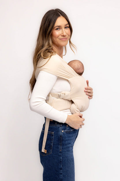 Mom wearing WildBird Sparrow Aerial Newborn Buckle Wrap front carry facing in