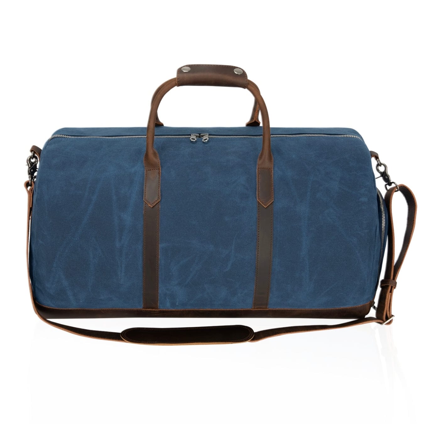 Blue duffel bag with brown leather straps and handle on a white background