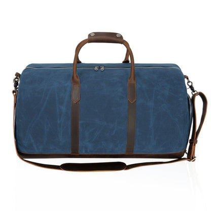 Blue duffel bag with brown leather straps and handle on a white background