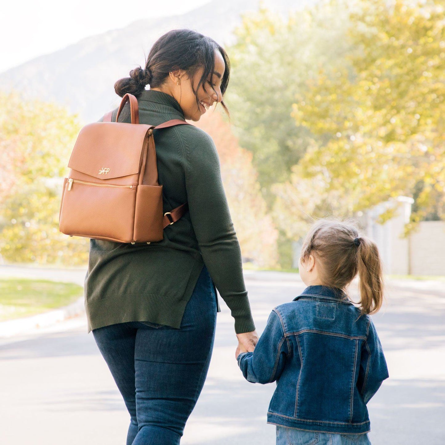 Mom with Freshly Picked butterscotch vegan leather mini diaper bag backpack with front pocket
