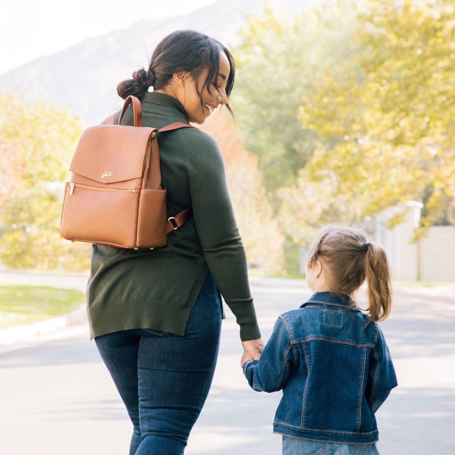 Mom with Freshly Picked butterscotch vegan leather mini diaper bag backpack with front pocket