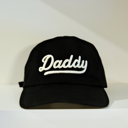Lalabu Daddy hat in black with 3D white embroidered script, adjustable strap, recycled polyester