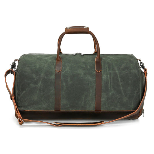 Green duffel bag with brown leather straps on a white background