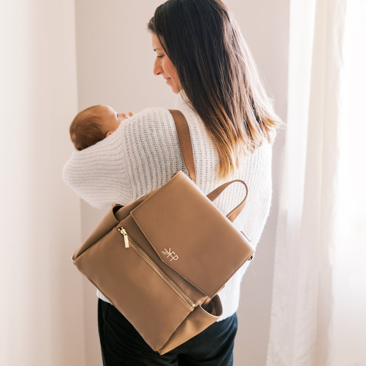 Mom with the Toffee vegan leather mini diaper bag backpack with multiple pockets by Freshly Picked