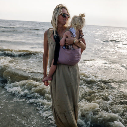 Mom holding a toddler ith Widride sling carrier